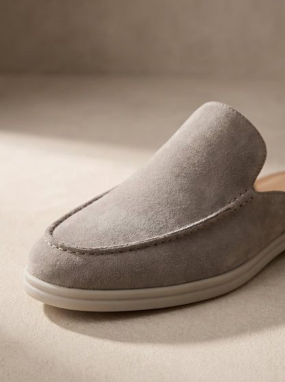 Mocasín mule de ante gris claro con suela blanca y perfil curvo