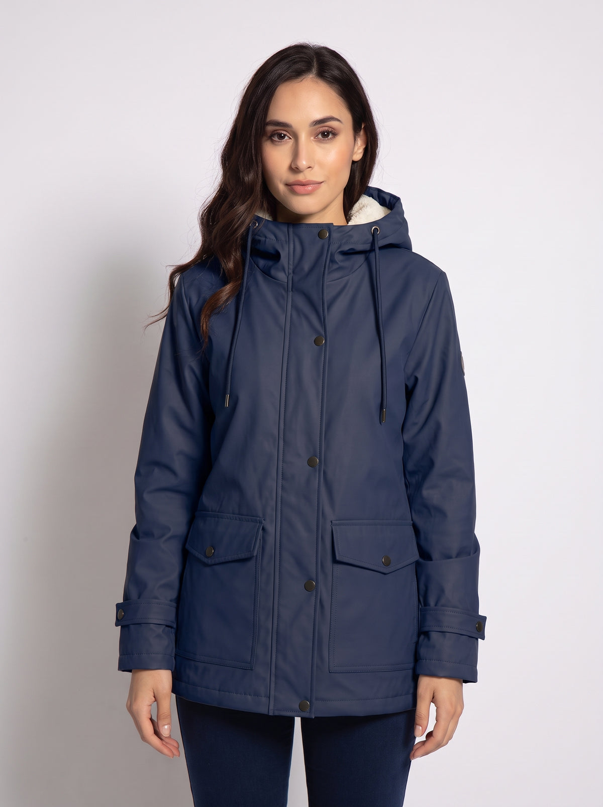 Chaqueta con capucha azul marino, cierre frontal con botones y bolsillos.